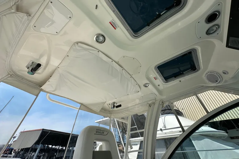  Yacht Photos Pics Interior view of 2013 Boston Whaler 345 Conquest boat, showcasing ceiling and seating details.