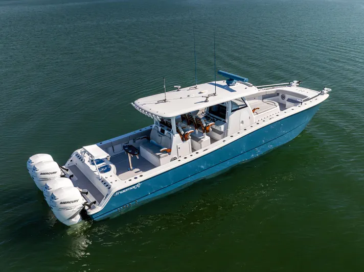  Yacht Photos Pics 2022 Freeman 43 boat on water with triple Mercury engines, blue and white design.