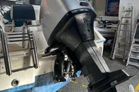 2007 Quicksilver 600 Commander boat with outboard motor in a workshop setting.