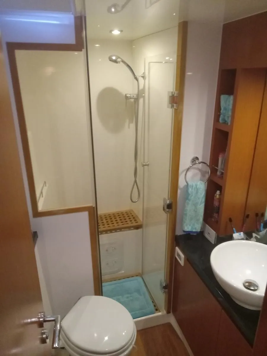 Modern bathroom in 2016 Aquila 44 yacht with shower, sink, and toilet.
