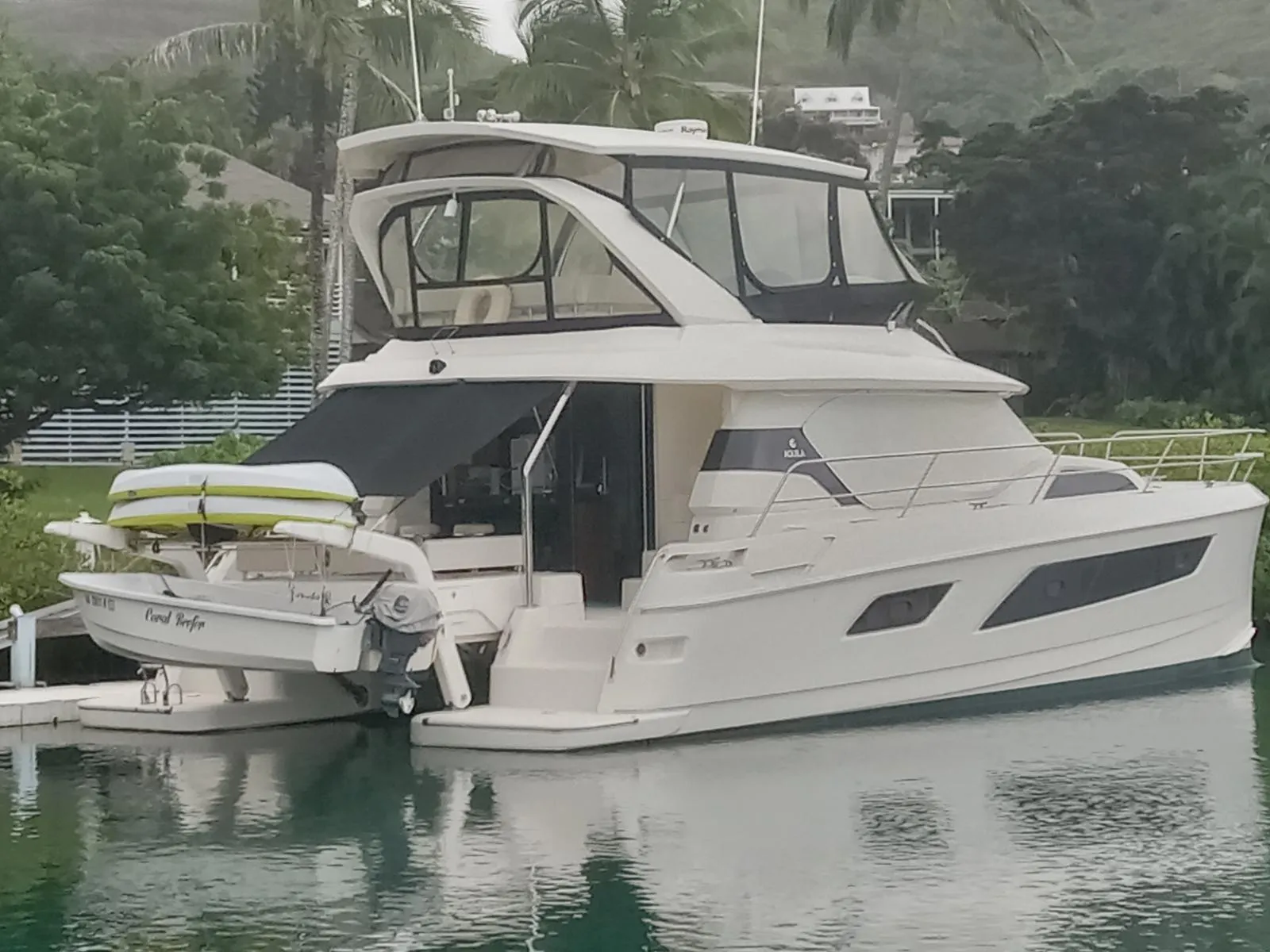 Aquila 44 yacht, 2016 model, docked in a serene marina setting.