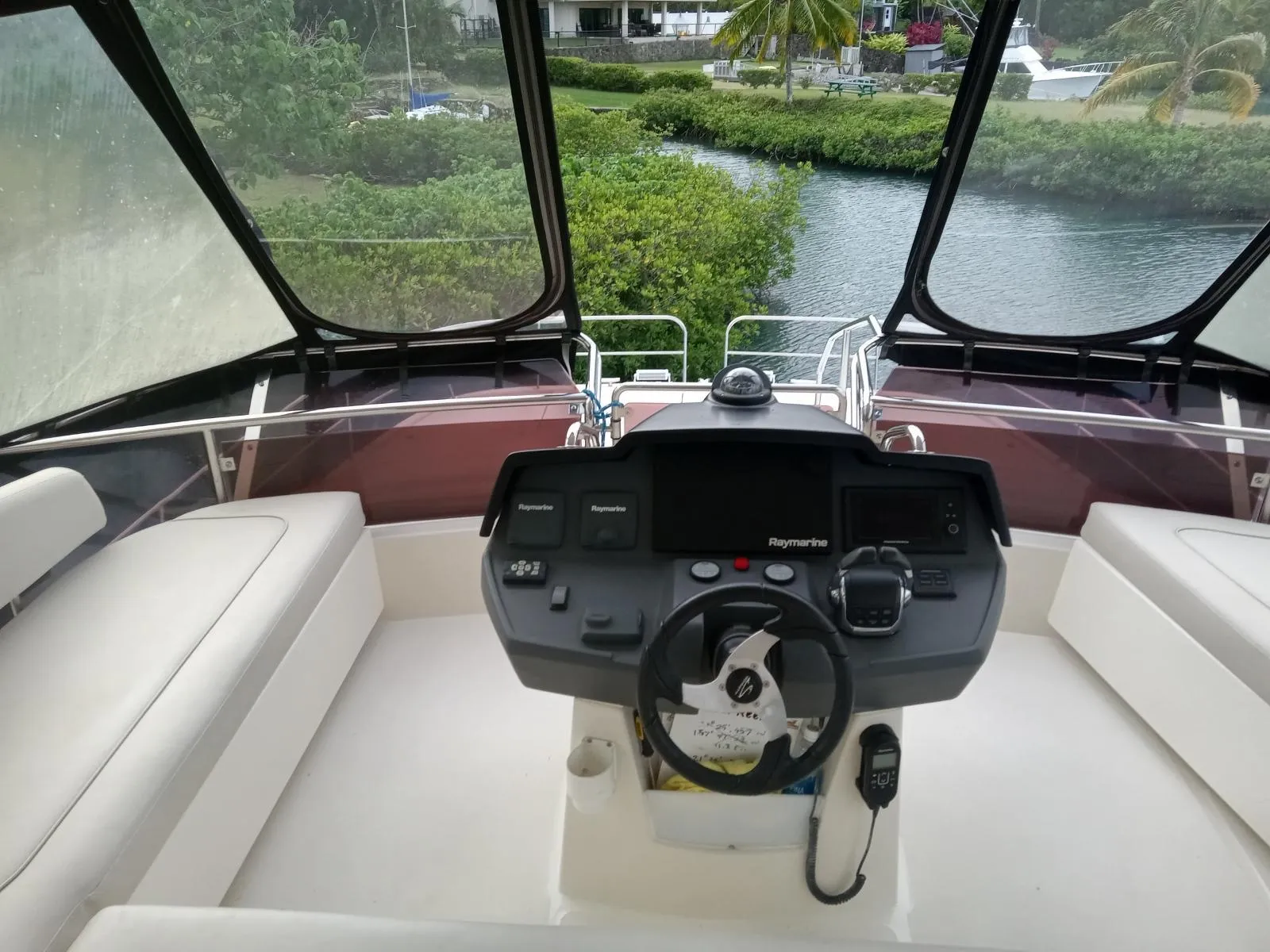 Helm of 2016 Aquila 44 yacht with panoramic view and modern controls.