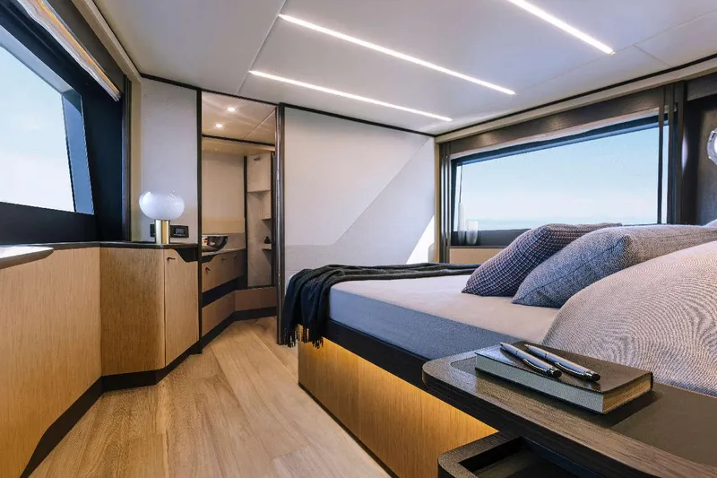  Yacht Photos Pics Luxurious bedroom interior of 2026 Absolute 52 FLY yacht with modern design and large windows.