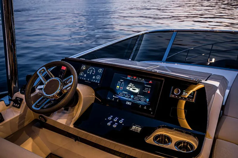  Yacht Photos Pics Luxurious helm of 2026 Absolute 52 FLY yacht with advanced navigation displays at sunset.