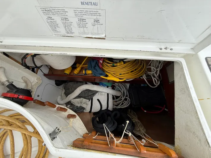 French Angel Yacht Photos Pics Storage compartment of a 2003 Beneteau 393 sailboat with ropes and equipment.