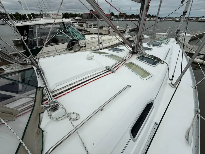 French Angel Yacht Photos Pics 2003 Beneteau 393 sailboat deck with rigging, docked in a marina.