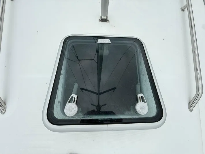 French Angel Yacht Photos Pics Deck hatch of a 2003 Beneteau 393 sailboat, featuring stainless steel handles.