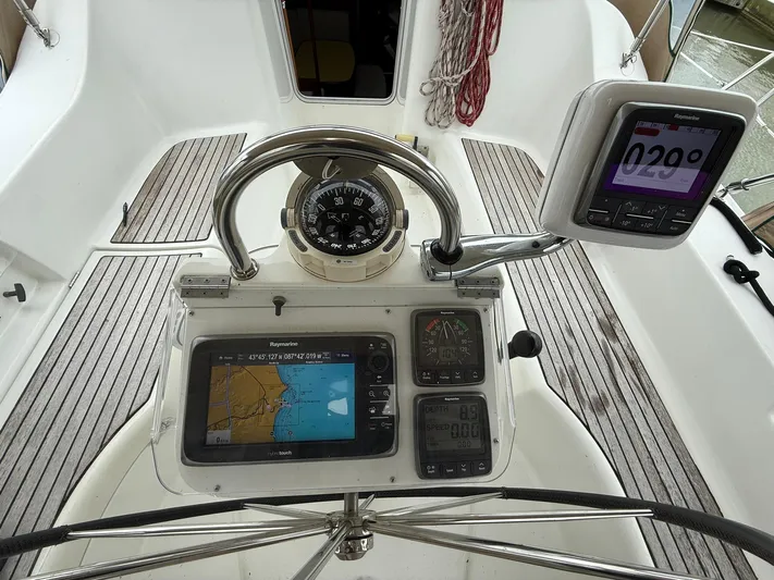 French Angel Yacht Photos Pics Cockpit of 2003 Beneteau 393 sailboat with navigation instruments and compass.