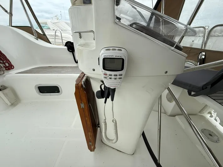 French Angel Yacht Photos Pics Cockpit of 2003 Beneteau 393 sailboat with radio equipment and steering console.