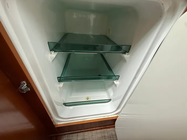French Angel Yacht Photos Pics Empty refrigerator with glass shelves inside a 2003 Beneteau 393 yacht.