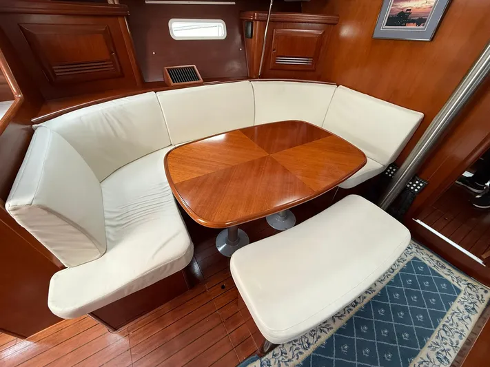 French Angel Yacht Photos Pics Luxurious interior of 2003 Beneteau 393 yacht with elegant wood and cream seating.