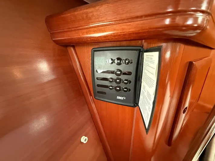 French Angel Yacht Photos Pics Control panel on 2003 Beneteau 393 yacht's wooden interior.