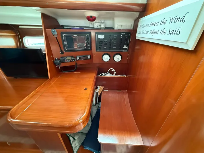 French Angel Yacht Photos Pics Interior of 2003 Beneteau 393 sailboat with navigation equipment and motivational sign.