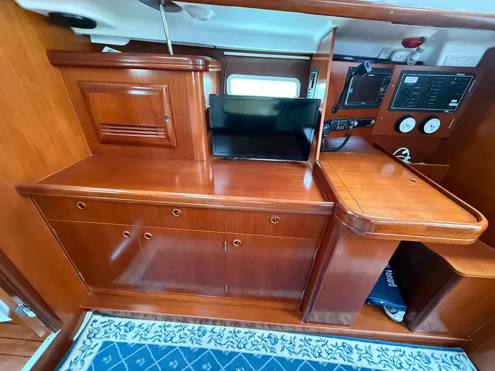 French Angel Yacht Photos Pics Interior of 2003 Beneteau 393 yacht with wooden cabinetry and navigation equipment.