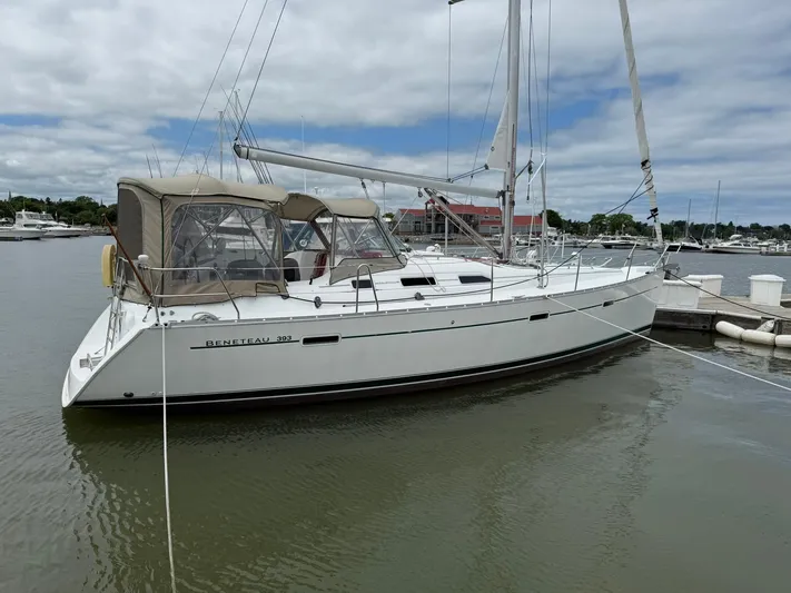 French Angel Yacht Photos Pics 2003 Beneteau 393 sailboat docked in a marina under cloudy skies.