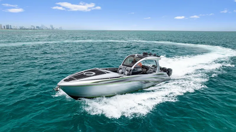 Baby Yacht Photos Pics 2018 Deep Impact 399 Cabin boat cruising on open water.