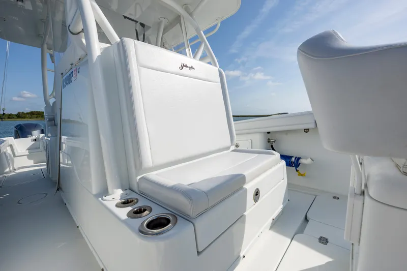  Yacht Photos Pics 2019 Yellowfin 36 boat interior with white seating and cup holders, under a clear blue sky.