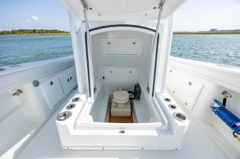  Yacht Photos Pics 2019 Yellowfin 36 boat with open deck hatch and marine toilet, on calm water.