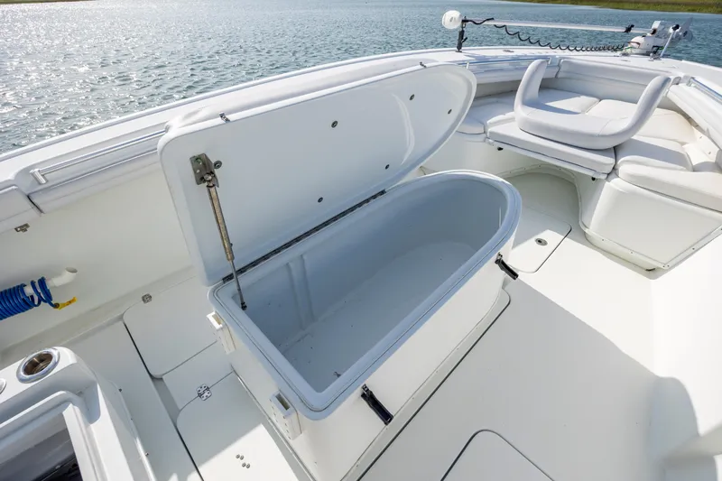  Yacht Photos Pics 2019 Yellowfin 36 boat with open storage compartment on deck, near water.