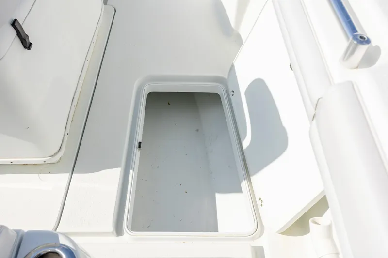  Yacht Photos Pics 2019 Yellowfin 36 boat storage compartment, open and empty, with white interior.