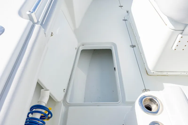  Yacht Photos Pics 2019 Yellowfin 36 boat interior with open storage compartment and hose.