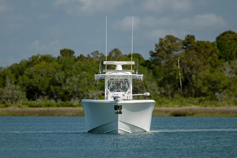  Yacht Photos Pics 2019 Yellowfin 36 boat on calm water with forested background.