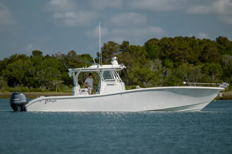  Yacht Photos Pics 2019 Yellowfin 36 boat on calm water with trees in the background.