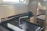 Modern kitchen interior of 2023 Hanse 388 yacht with sleek design and compact layout.