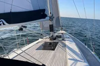 2023 Hanse 388 sailboat on open sea, showcasing deck and sails.