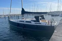 2023 Hanse 388 sailboat docked at a marina under clear blue skies.