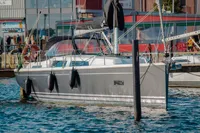 2023 Hanse 388 yacht docked in a marina, featuring sleek design and modern rigging.