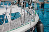 2023 Hanse 388 yacht deck with railing, docked on calm blue water.