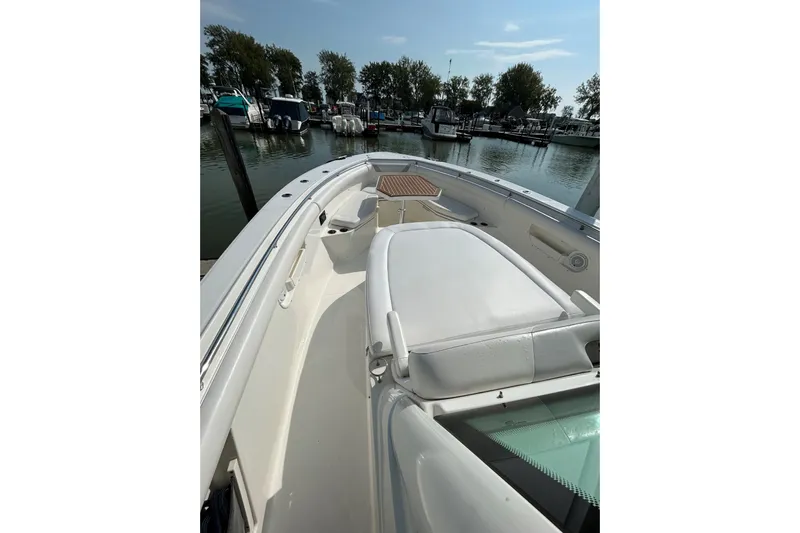  Yacht Photos Pics 2016 Boston Whaler 370 Outrage boat interior at marina, featuring seating and calm waters.