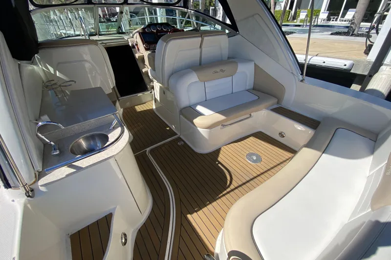  Yacht Photos Pics 2008 Sea Ray Sundancer 330 interior with seating, sink, and wood flooring.