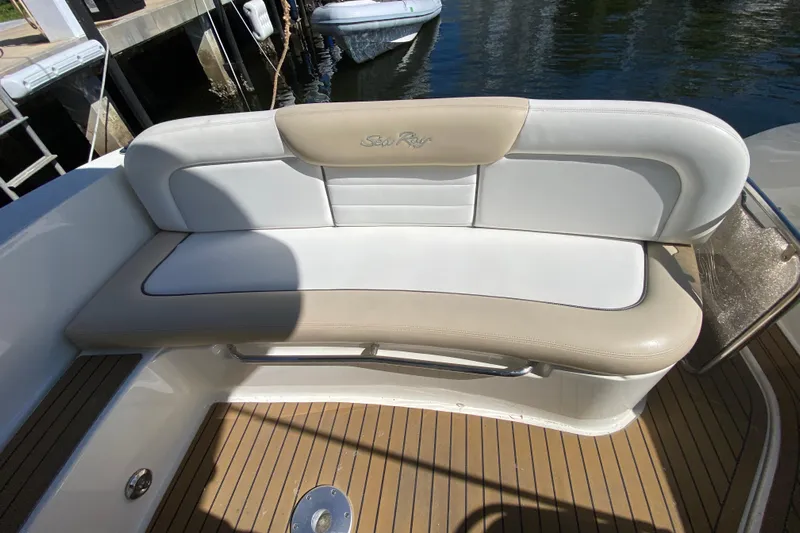  Yacht Photos Pics 2008 Sea Ray Sundancer 330 boat seating with beige and white upholstery, docked by the water.