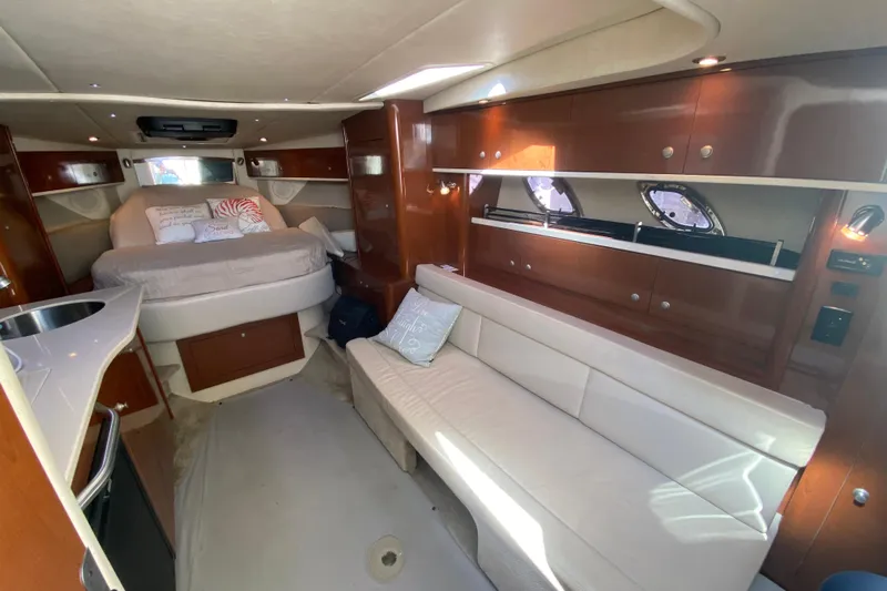  Yacht Photos Pics Luxurious 2008 Sea Ray Sundancer 330 cabin interior with bed, sofa, and kitchenette.