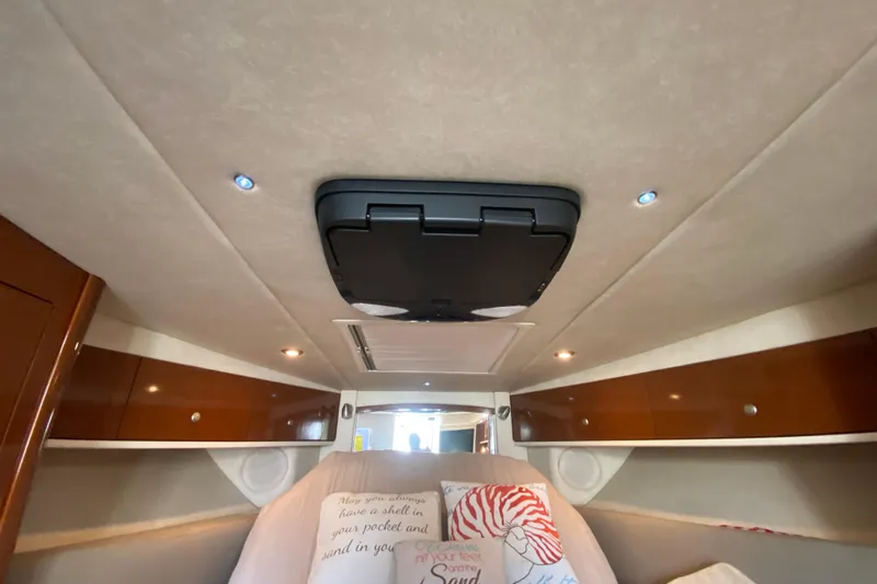  Yacht Photos Pics Interior cabin of 2008 Sea Ray Sundancer 330 with cozy bedding and wooden accents.