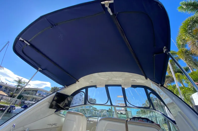 Yacht Photos Pics 2008 Sea Ray Sundancer 330 boat interior with blue canopy and clear sky background.