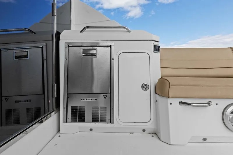 Best Times Too W/ Seakeeper Roll Stabilizer Yacht Photos Pics 2014 Cruisers Yachts 45 Cantius interior with stainless steel appliances and beige seating.