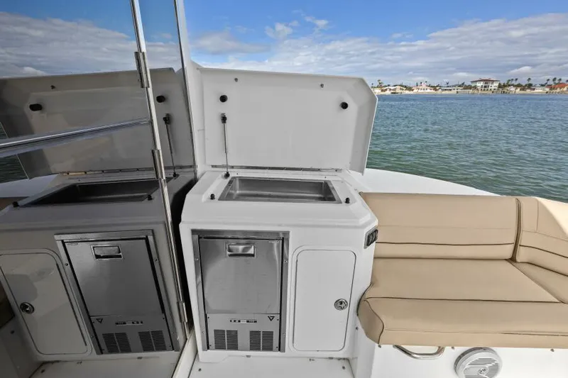 Best Times Too W/ Seakeeper Roll Stabilizer Yacht Photos Pics Outdoor kitchenette on 2014 Cruisers Yachts 45 Cantius, featuring sink and seating, with ocean view.
