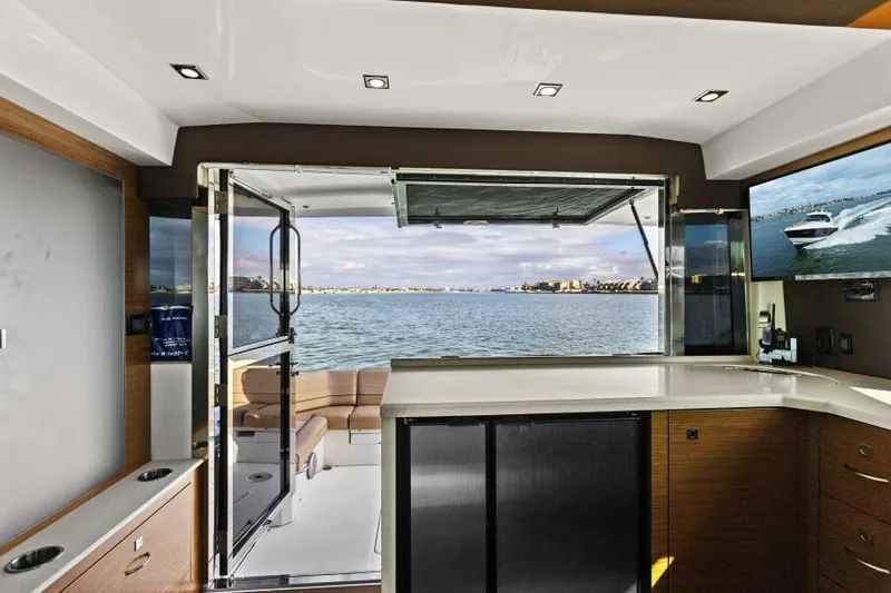 Best Times Too W/ Seakeeper Roll Stabilizer Yacht Photos Pics Interior view of 2014 Cruisers Yachts 45 Cantius with open deck and water view.