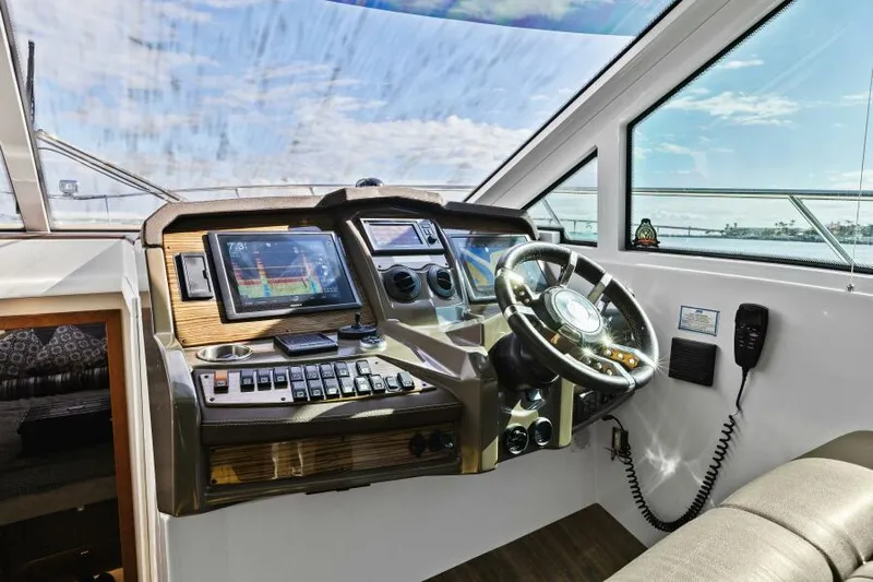 Best Times Too W/ Seakeeper Roll Stabilizer Yacht Photos Pics 2014 Cruisers Yachts 45 Cantius helm with modern navigation controls and steering wheel.