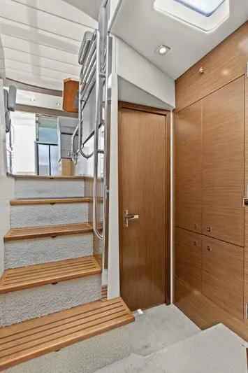 Best Times Too W/ Seakeeper Roll Stabilizer Yacht Photos Pics Interior of 2014 Cruisers Yachts 45 Cantius with wooden stairs and modern design.