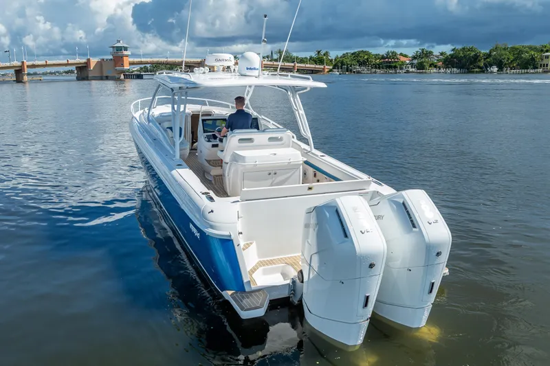  Yacht Photos Pics 2018 Intrepid 407 boat with dual engines on calm water, bridge in background.
