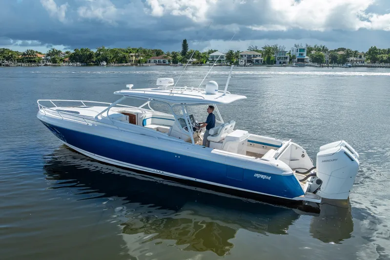  Yacht Photos Pics 2018 Intrepid 407 boat on calm water, featuring sleek design and powerful Mercury engines.