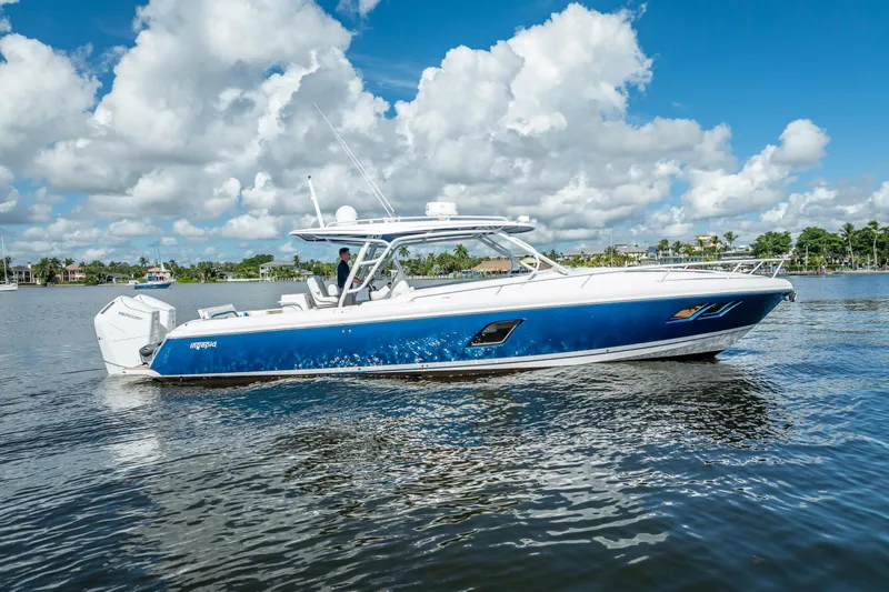  Yacht Photos Pics 2018 Intrepid 407 boat on calm water under a blue sky with clouds.