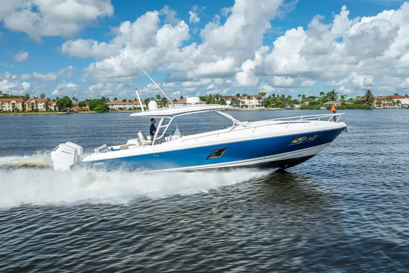  Yacht Photos Pics 2018 Intrepid 407 boat cruising on a sunny day, blue water and sky backdrop.