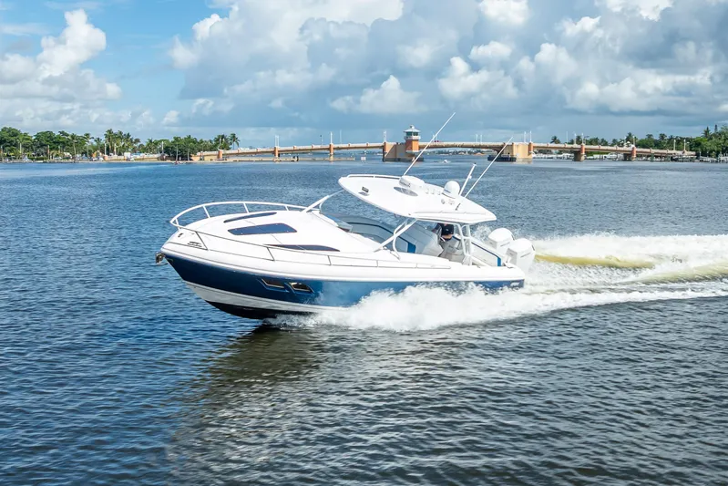  Yacht Photos Pics 2018 Intrepid 407 boat cruising on a sunny day with a scenic bridge backdrop.