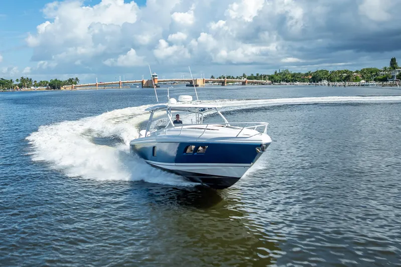  Yacht Photos Pics 2018 Intrepid 407 boat cruising on a sunny day with scenic waterfront backdrop.