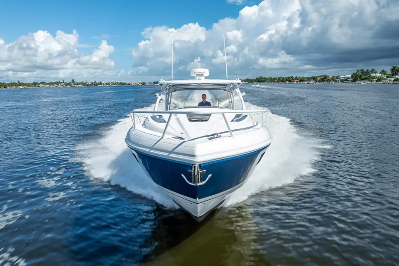  Yacht Photos Pics 2018 Intrepid 407 boat cruising on a sunny day with blue skies and calm waters.
